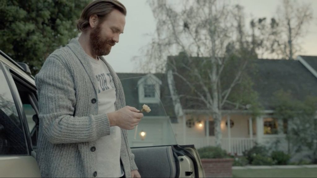 A father regards a flower with a smile in a still from Subaru's Making Memories ad